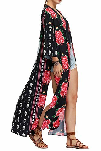 Woman wearing floral and skull patterned kimono with denim shorts and sandals.