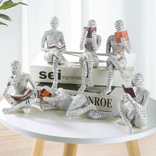 Abstract figures reading books on a table