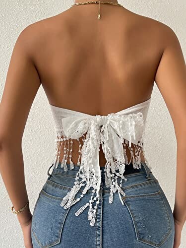 Woman wearing a backless lace top with jeans.
