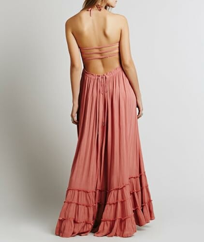 Woman in a backless pink maxi dress with straps