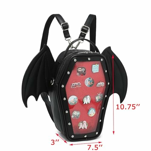 Black coffin-shaped backpack with bat wings and assorted badges.