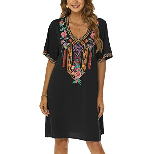 Woman wearing a black dress with colorful embroidery.
