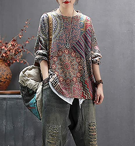 Person wearing a colorful bohemian patterned sweater and casual pants