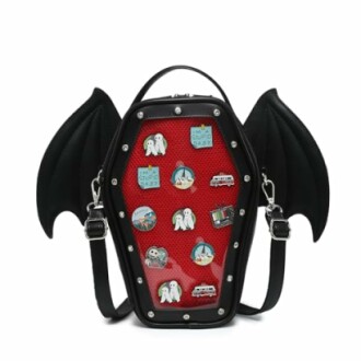 Coffin-shaped backpack with bat wings and assorted pins.