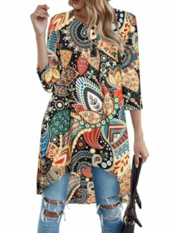 Woman wearing a colorful bohemian tunic with ripped jeans
