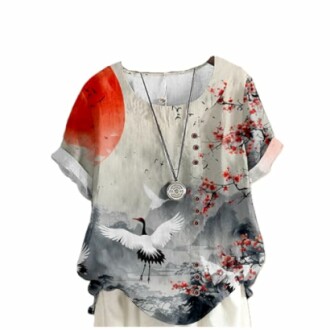 Blouse with crane and floral design on a white background.