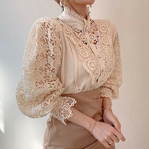 Woman wearing an elegant lace blouse with intricate patterns.