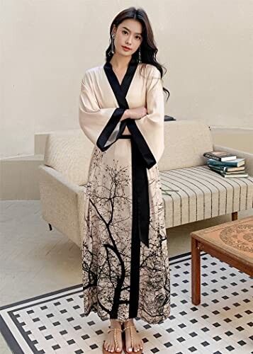 Woman wearing a long dress with tree branch pattern.