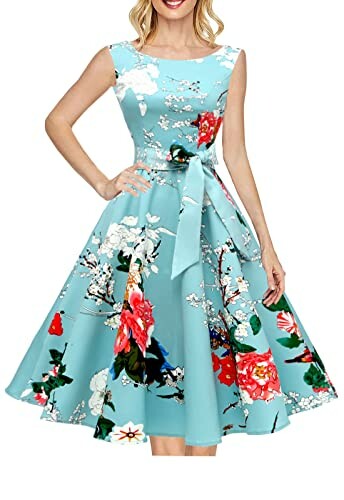 Woman wearing a turquoise floral swing dress with a bow.