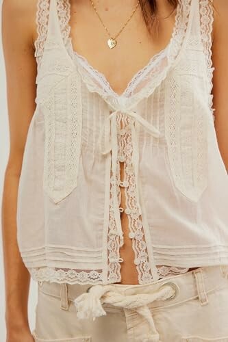 Lace tank top with heart necklace.