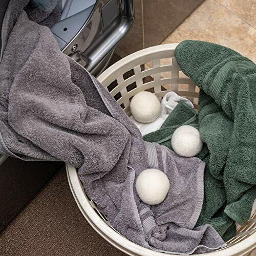 Laundry basket with towels and dryer balls.