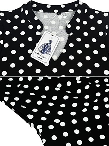 Close-up of black dress with white polka dots and a tag.