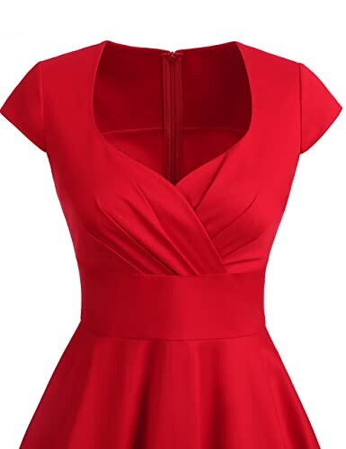 Red vintage-style dress with V-neck and cap sleeves.