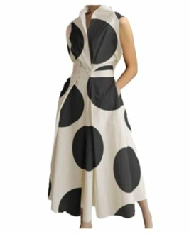 Sleeveless dress with large black polka dots.