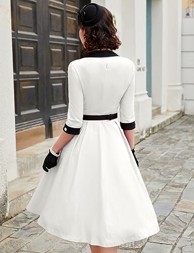 Woman in vintage white dress walking on stone path