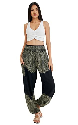 Woman wearing a white crop top and patterned boho pants