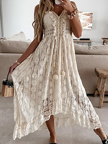 Woman wearing a lace dress standing in a living room.