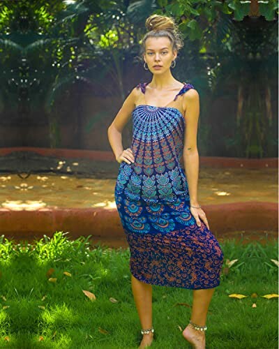 Woman in a colorful sundress standing in a garden.