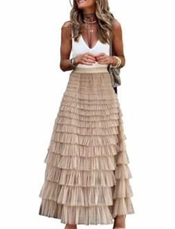 Woman in a white top and tiered beige skirt.