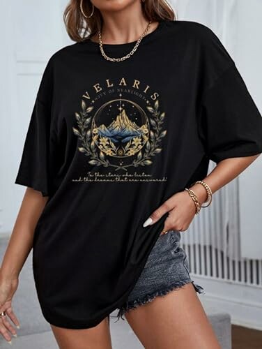 Woman in black Velaris t-shirt and denim shorts.